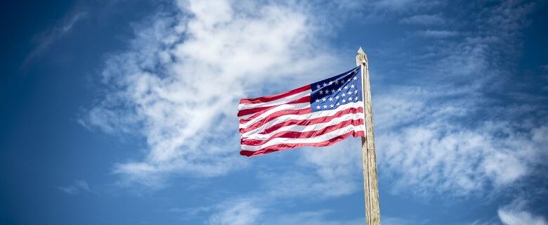 American Flag flying in blue sky