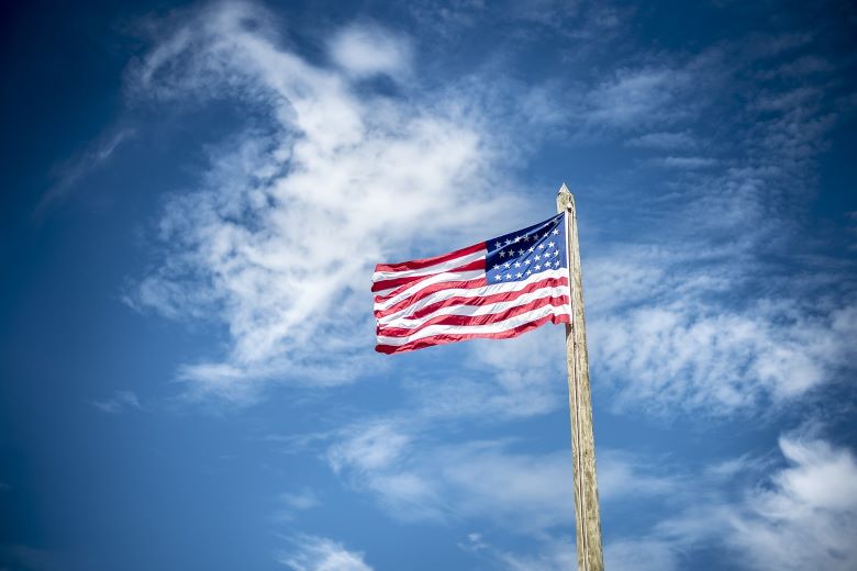 American Flag flying in blue sky